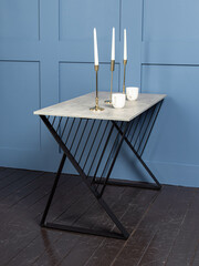 Loft-style dining table on blue wall background. Kitchen in loft style interior 