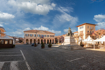 Fototapeta na wymiar Peveragno, Cuneo, Italy - January 09, 2023: piazza Pietro Toselli with the town hall in neoclassical style and the monument to Major Pietro Toselli