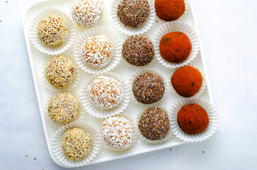 Assorted vegan sweets, Delicious Candy Balls with seeds, dried fruit and cocoa powder, Healthy Candies