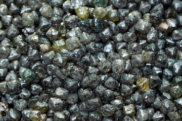 Rough technical industrial quality diamonds on black background. High quality photo