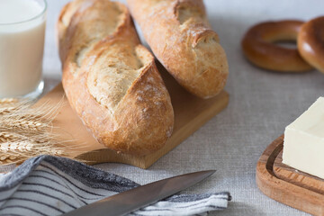 Fresh delicious bread close-up. Freshly baked sourdough bread with a golden crust on a wooden board. The context of a bakery with delicious bread. Confectionery products.