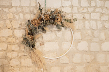 A wreath of dried hydrangea, pampas and eucalyptus at a wedding