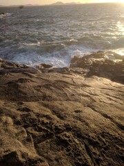 Sunset Over The Sea, with Rocks and Waves