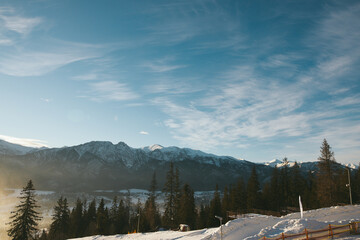 Landscape of coniferous trees and mountains against the blue sky. Winter Tatra mountains. Europe