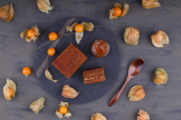 Honey cake. classic honey cake. on a dark slate or concrete background. Cut and slice of cake. The concept of home baking