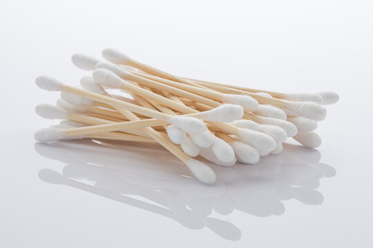 Pile of cotton swabs made of bamboo on bright white background.