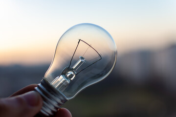 Edisonon light bulb on city sunset background