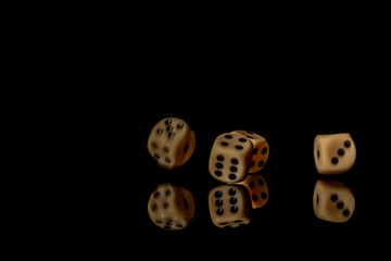 Game cubes on shiny black table with dark reflection