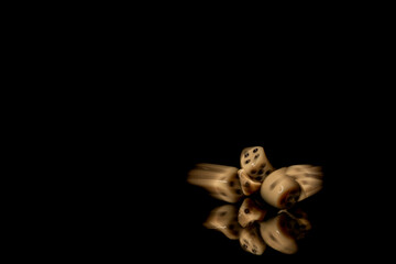 Game cubes on shiny black table with dark reflection
