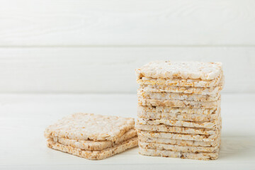 Stack of crispy rice cakes on white texture wood. Diet bread. Diet. proper nutrition. GLUTEN FREE. Copy space. Place for text.