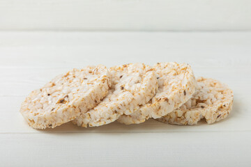 Stack of crispy rice cakes on white texture wood. Diet bread. Diet. proper nutrition. GLUTEN FREE. Copy space. Place for text.