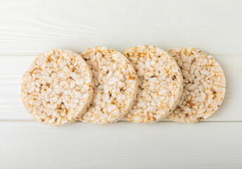 Stack of crispy rice cakes on white texture wood. Diet bread. Diet. proper nutrition. GLUTEN FREE. Copy space. Place for text.