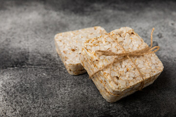 Stack of crispy rice cakes on black textured background. Diet bread. Diet. proper nutrition. GLUTEN FREE. Copy space. Place for text.