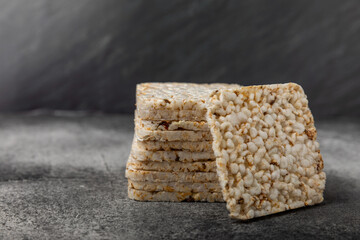 Stack of crispy rice cakes on black textured background. Diet bread. Diet. proper nutrition. GLUTEN FREE. Copy space. Place for text.