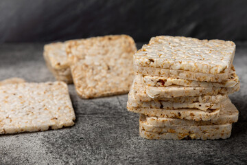 Stack of crispy rice cakes on black textured background. Diet bread. Diet. proper nutrition. GLUTEN FREE. Copy space. Place for text.