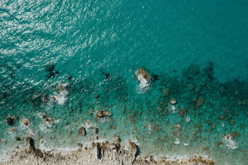 Seascape and rocky beach with turquoise clear waters in Greece