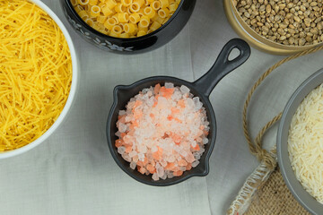 Pink Himalayan salt in bowl. Ingredient in cooking. Top view.