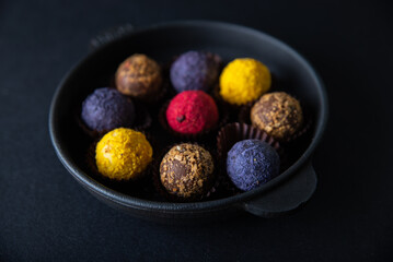 Sweets multi-colored round on a dark concrete background