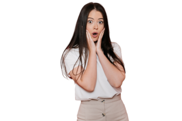 Shocked young brunette wonman in casual with wide opened eyes and mouth puts palms on cheeks in surprised expression against transparent background. Discount, sale. Amazed European girl in disbelief.