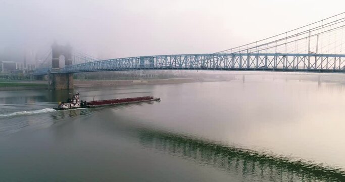 Ohio River barge passing under a bridge