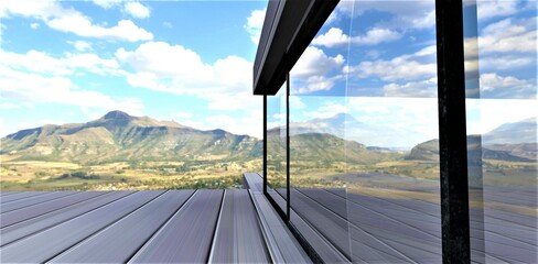 Reflection of a picturesque mountain landscape in a large mirrored window with a heat-saving three-chamber double-glazed window. 3d rendering.