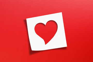 Heart shaped on note paper with red background
