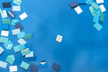 Background of colorful correspondence envelopes in shades of blue and white.  Crinkled paper with text, 