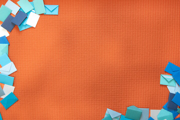 Background of colorful correspondence envelopes in shades of blue and white. Bright orange textured...