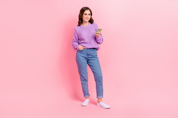 Full length photo of shiny cute lady wear violet sweater typing instagram twitter facebook modern device isolated pink color background