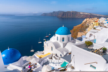 Santorini island, Greece. Traditional and famous houses and churches with blue domes over the Caldera, Aegean sea