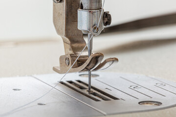 Sewing machine needle with thread and fabric