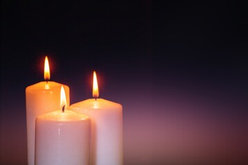 Abstract burning candle on dark background