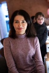 happy brunette girl in a lilac sweater for her birthday. A party.