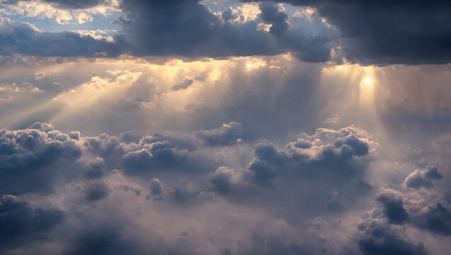An aerial shot above beautiful cloudscape with sun rays coming through the clouds, detailed picturesque view, camera flying to the storm rainy clouds with dense fog. © railwayfx