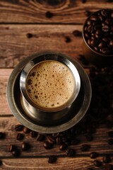 South Indian filter coffee served in steel cup and saucer, selective focus
