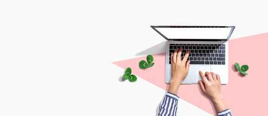 Laptop computer with shamrock leaves - flat lay