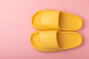 Home slippers on pink paper background, flat lay. Indoor shoes. Place for text. copy space