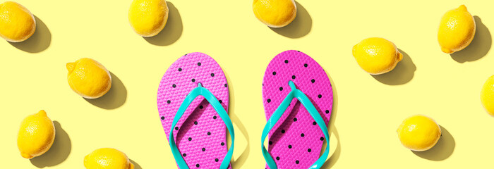 Summer concept with flip flops and lemons - flat lay