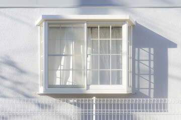 White window on the white wall house. It represent concepts of heaven, calmness, tranquility, peacefulness and happiness.