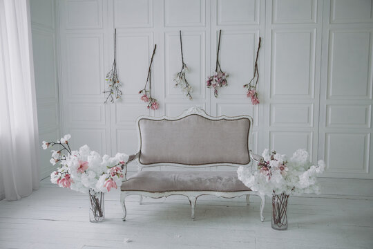 interior of a spring room with a sofa and flowers in a light style