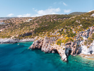 Drone shot of Zakynthos island with beautiful turquoise Ionian sea and limestone cliffs near famous Navagio beach during daytime - 559924998