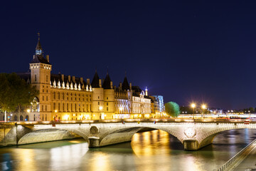 Fototapeta na wymiar Pont Change bridge and Conciergerie at night in Paris. France