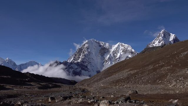 snow covered Himalaya mountains with blue sky and dramatic clouds
Wide shot from Nepal, 2023
