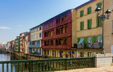 Fototapeta na wymiar Canal in the middle of buildings in Castres, France