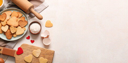 Composition with sweet heart-shaped cookies and ingredients on light background with space for text. Valentine's Day celebration