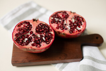 Side Angle of Pomegranate Halves on Cutting Board in Kitchen