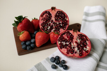Blueberries, Strawberries, Pomegranate on Cutting Board with Towel