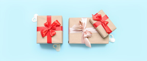 Beautiful gift boxes on light blue background. Valentine's Day celebration
