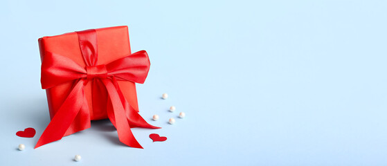 Beautiful gift box for Valentine's Day on light blue background with space for text