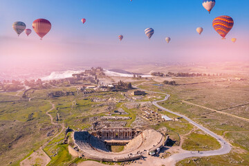 Concept Travel Pamukkale Turkey. Hot air balloon flying Travertine pool ancient amphitheater